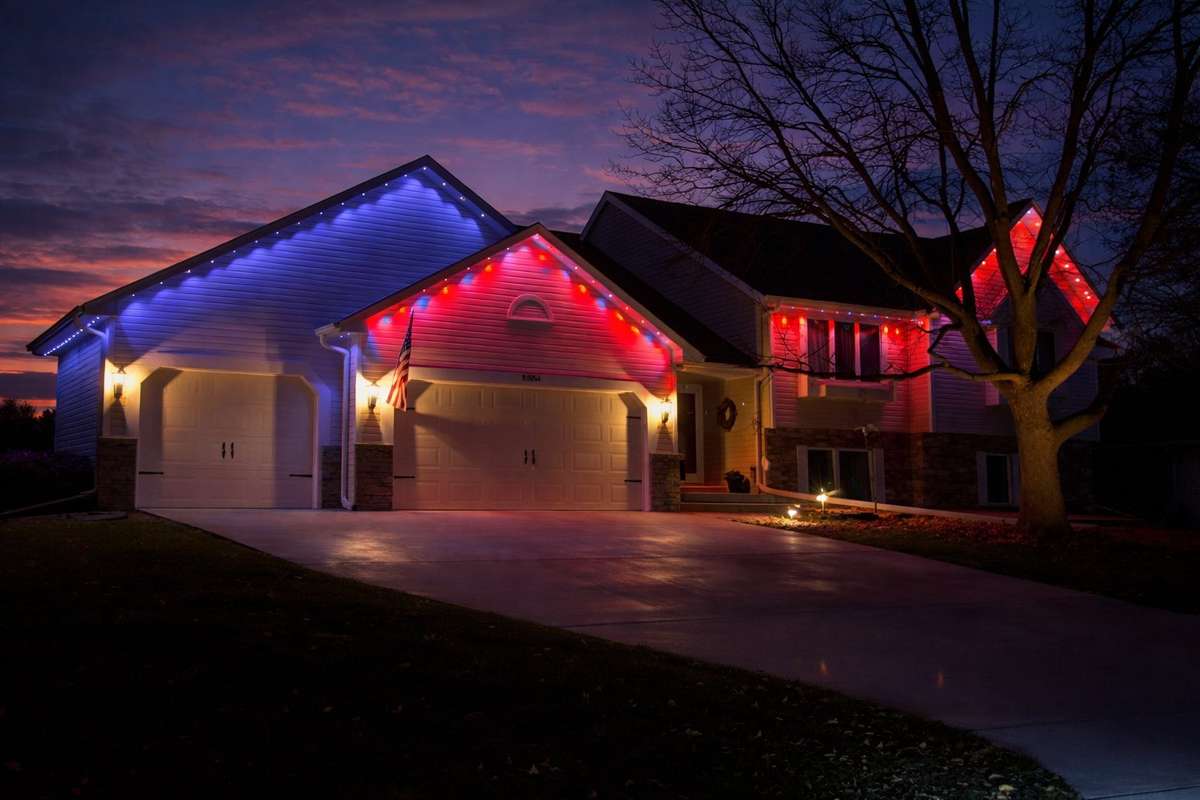 Patriotic red and blue lights on two-story home